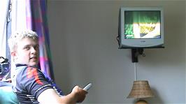 Gavin enjoys Norwegian television at the Haugastøl Tourist Centre while he waits for Michael to finish in the shower